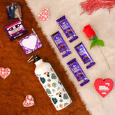 Valentine Gift Hamper with 'Tropical Leaves' Printed Water Bottle (750ml), Set of 2 Clip Magnets, Red Rose, Greeting Card & 4 Dairy Milk Chocolates