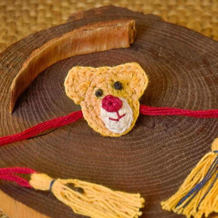 Dhavala, Teddy Bear, Teddy Bear with Bow, Swastika, Sun, Maati and Neel Nazar Battu Eco-friendly Seed Rakhi (Set of 7)