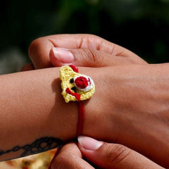 Dhavala, Teddy Bear, Teddy Bear with Bow, Swastika, Sun, Maati and Neel Nazar Battu Eco-friendly Seed Rakhi (Set of 7)