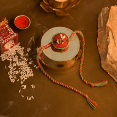 Neel Nazar Battu & Madhu Seed Rakhi Gift Hamper With Kaju Katli Mini Bites 125 gm
