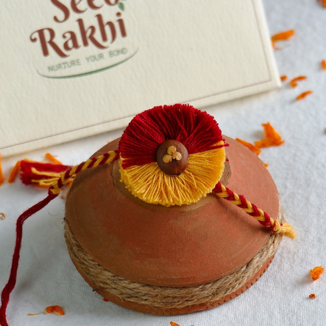 Amaltash &amp; Brinjal Seed Rakhi - Set of 2 Rakhi With Planter And Roli