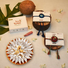 Neel Nazar Battu &amp; Madhu Seed Rakhi Gift Hamper With Kaju Katli Mini Bites 125 gm